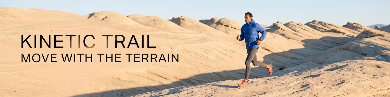 Ultrawide Kinetic Trail campaign with an adult runner crossing sandstone terrain