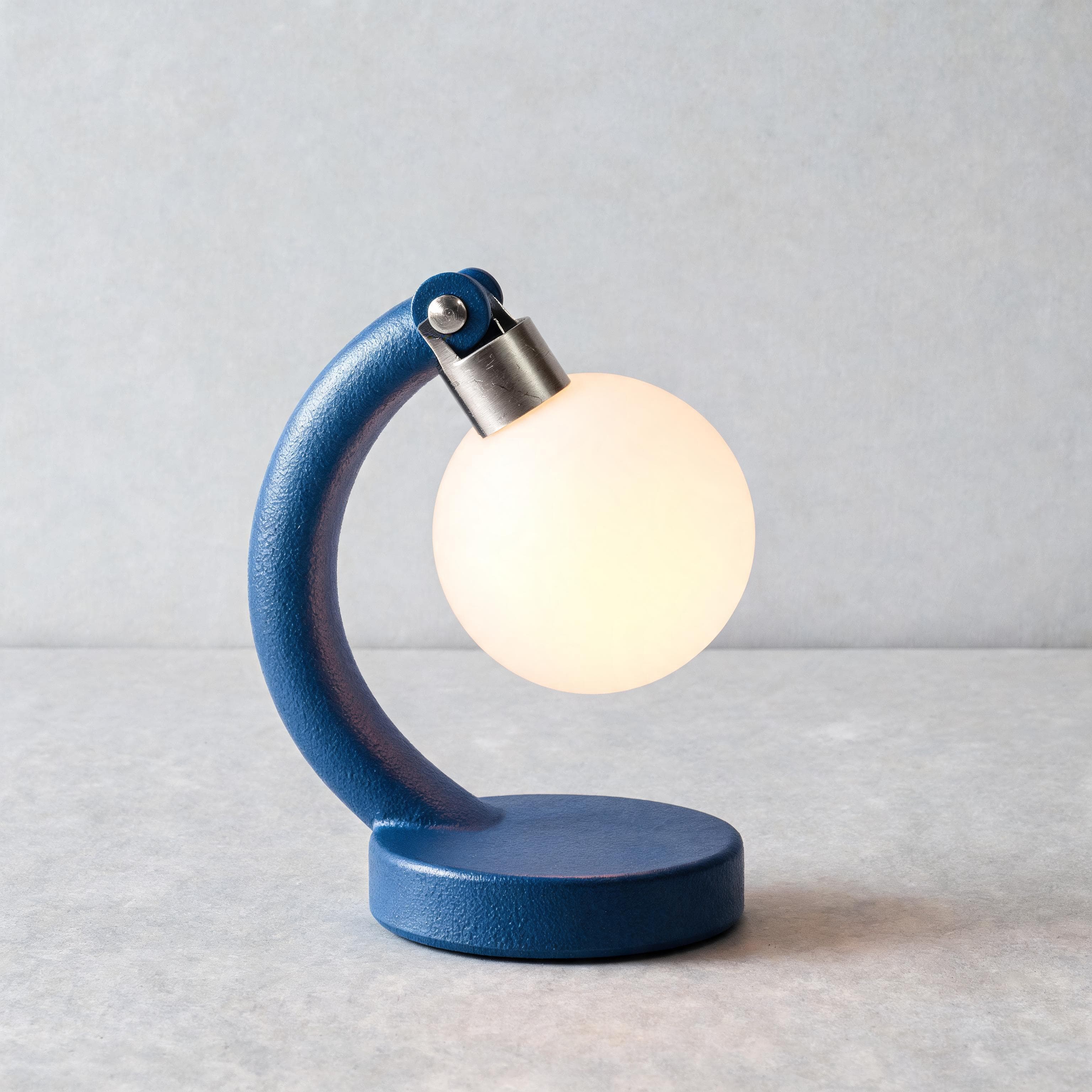 Seedream 5.0 Lite result showing a cobalt desk lamp on pale studio paper
